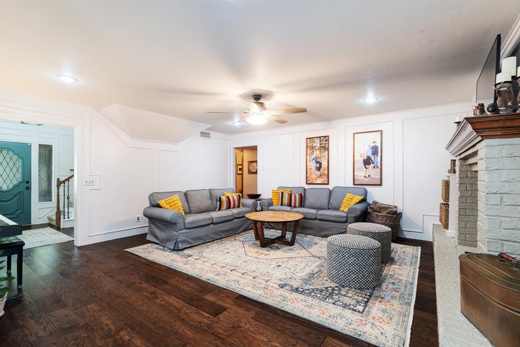 730 Cedar Creek Drive Reno, TX 75462 - Photo 4 of 28 a living room with furniture a fireplace and a flat screen tv
