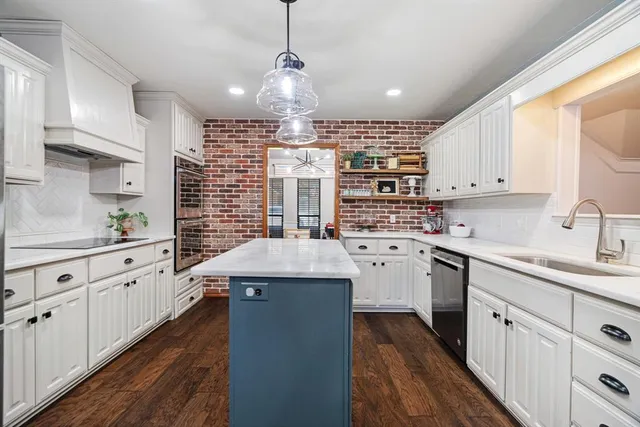 a kitchen with sink stove and cabinets