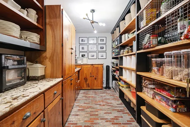 a hallway with wooden cabinets