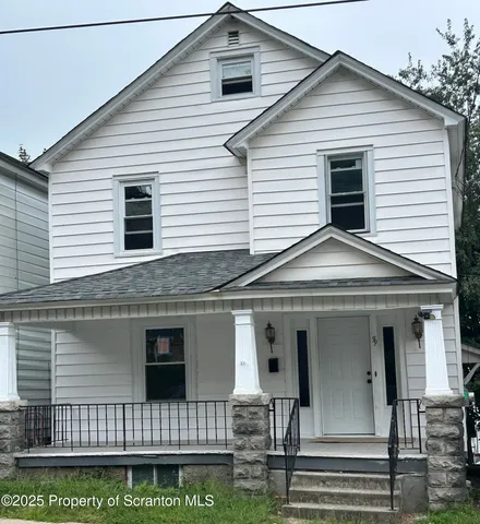a view of a white house with large windows