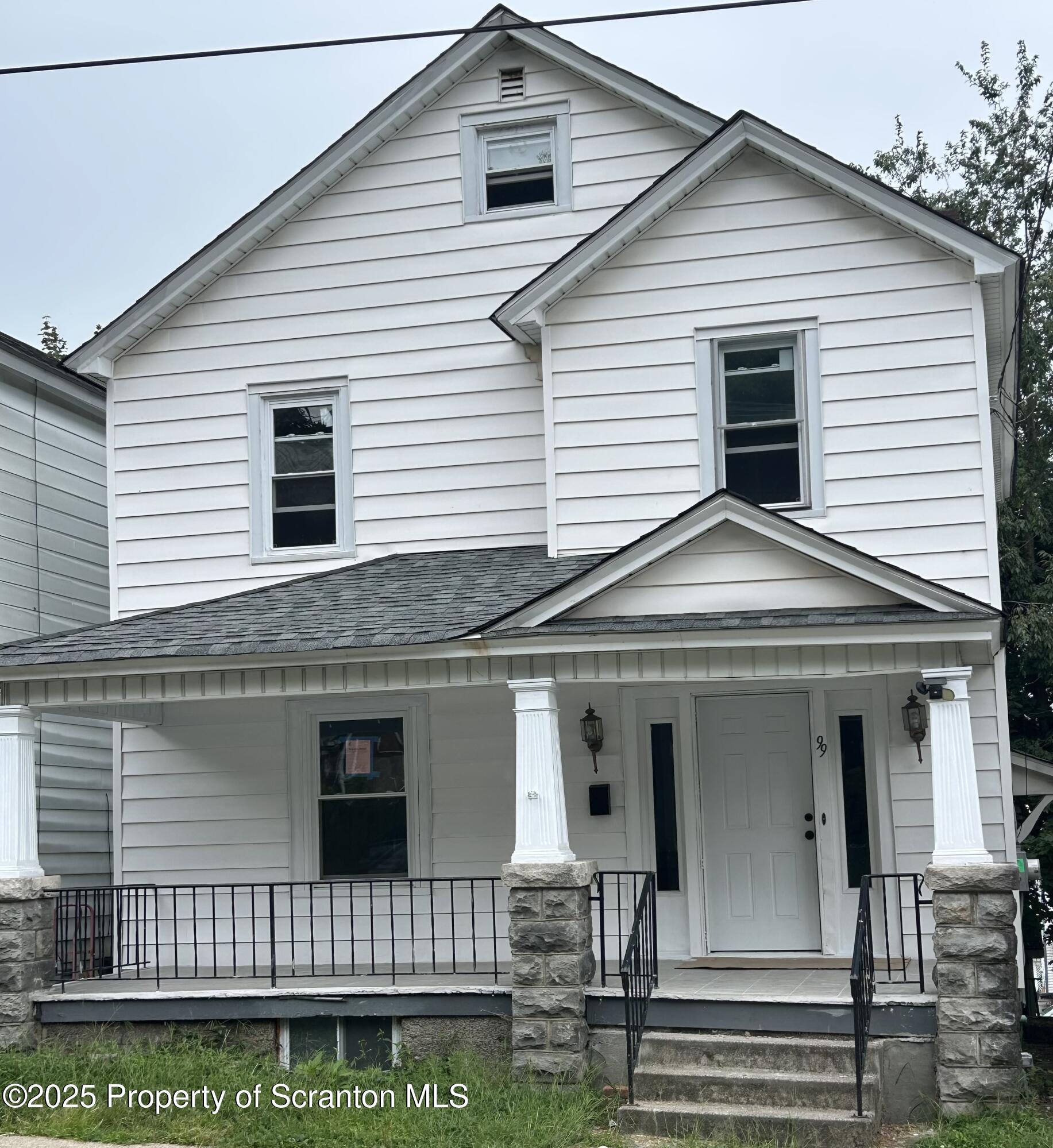 a view of a white house with large windows