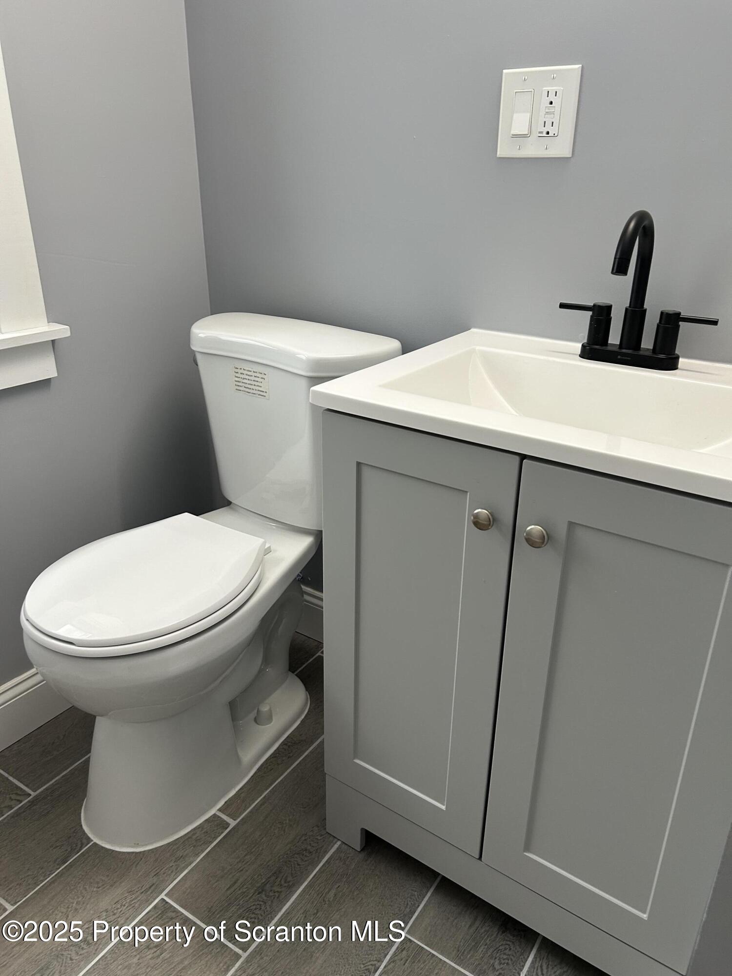 99 Washington Street Carbondale, PA 18407 - Photo 11 of 20 a white toilet sitting next to a bathroom sink