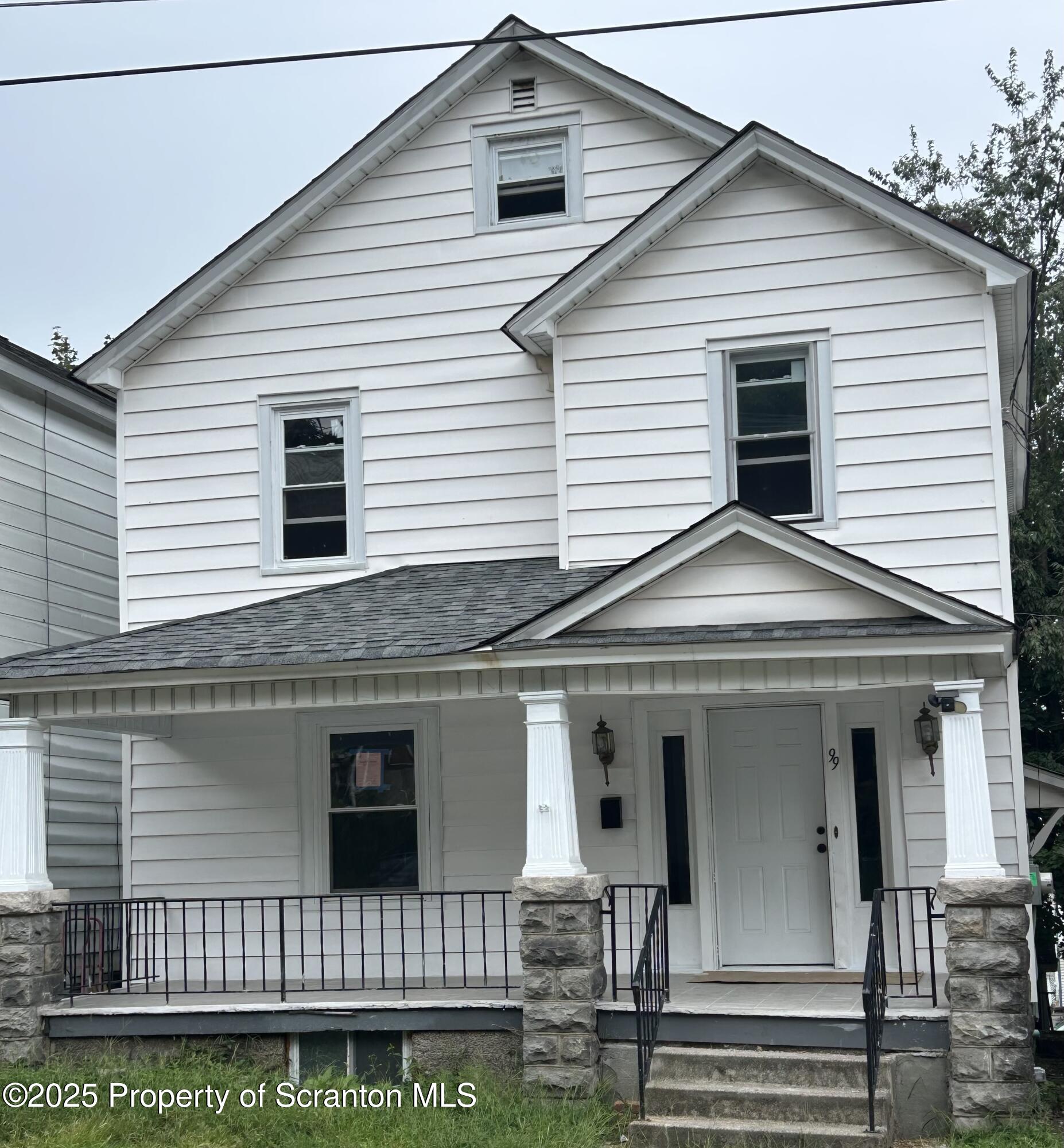 99 Washington Street Carbondale, PA 18407 - Photo 2 of 20 a view of a white house with large windows
