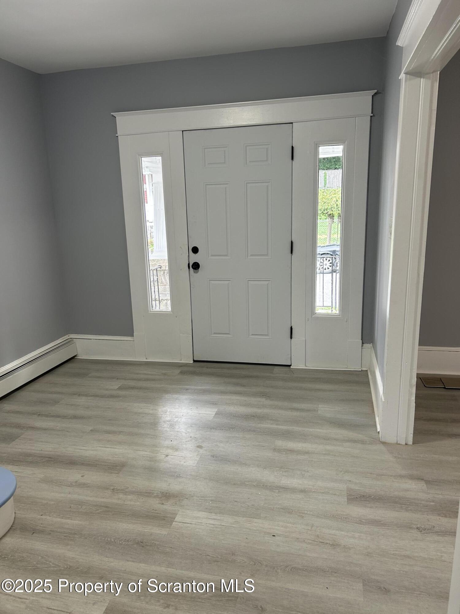 99 Washington Street Carbondale, PA 18407 - Photo 3 of 20 a view of empty room with wooden floor