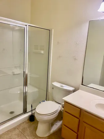 a bathroom with a toilet and a shower