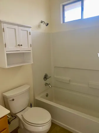 a bathroom with a toilet and a bathtub