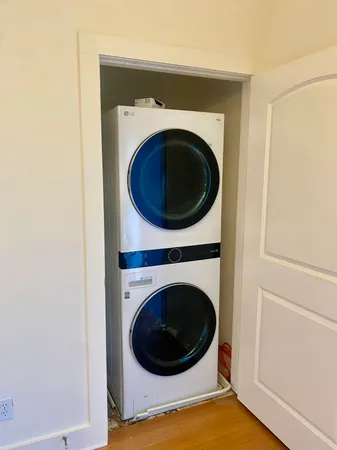 a view of a hallway with washer and dryer