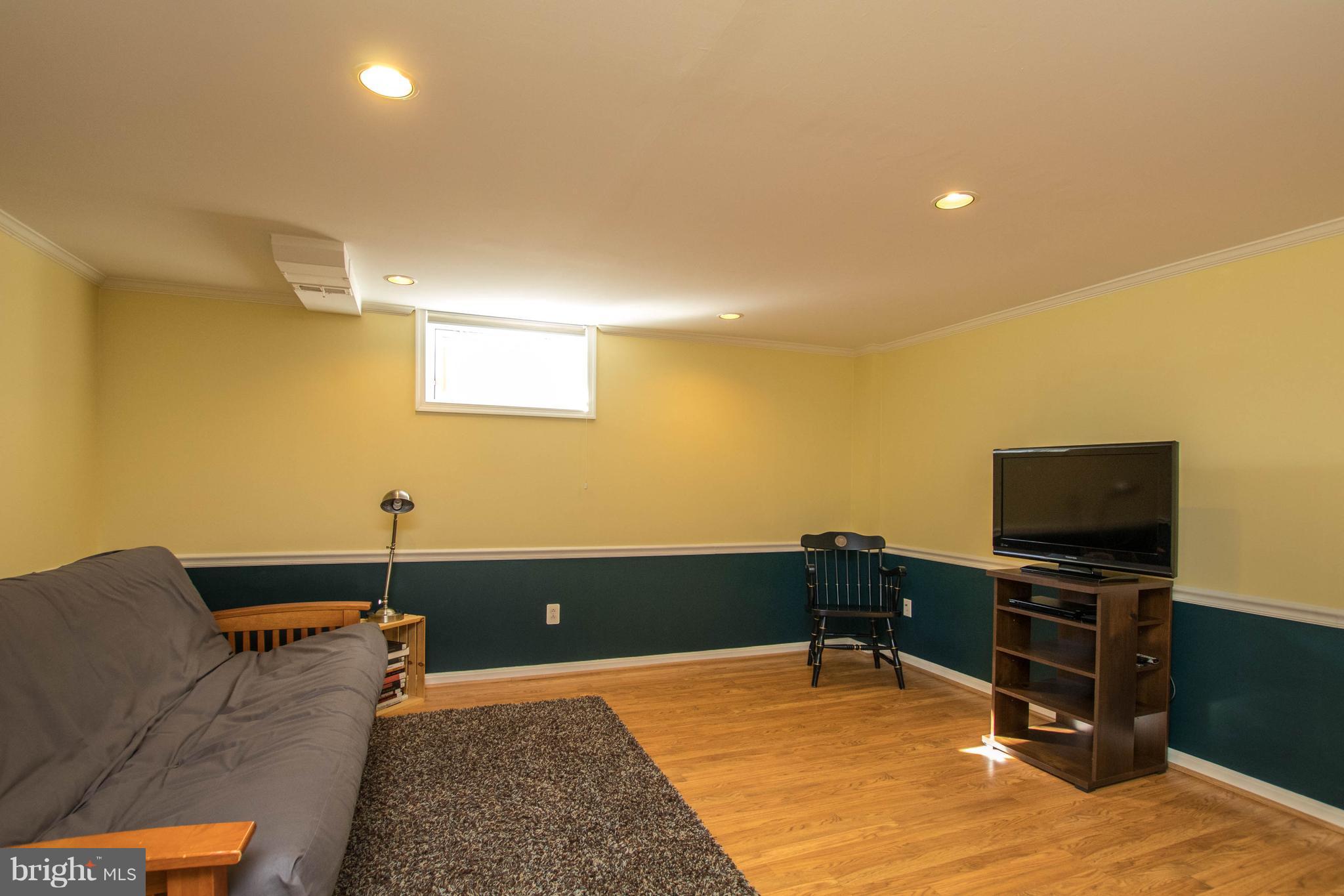 128 Overbrook Road Baltimore, MD 21212 - Photo 19 of 29 a room with a bed and a flat screen tv