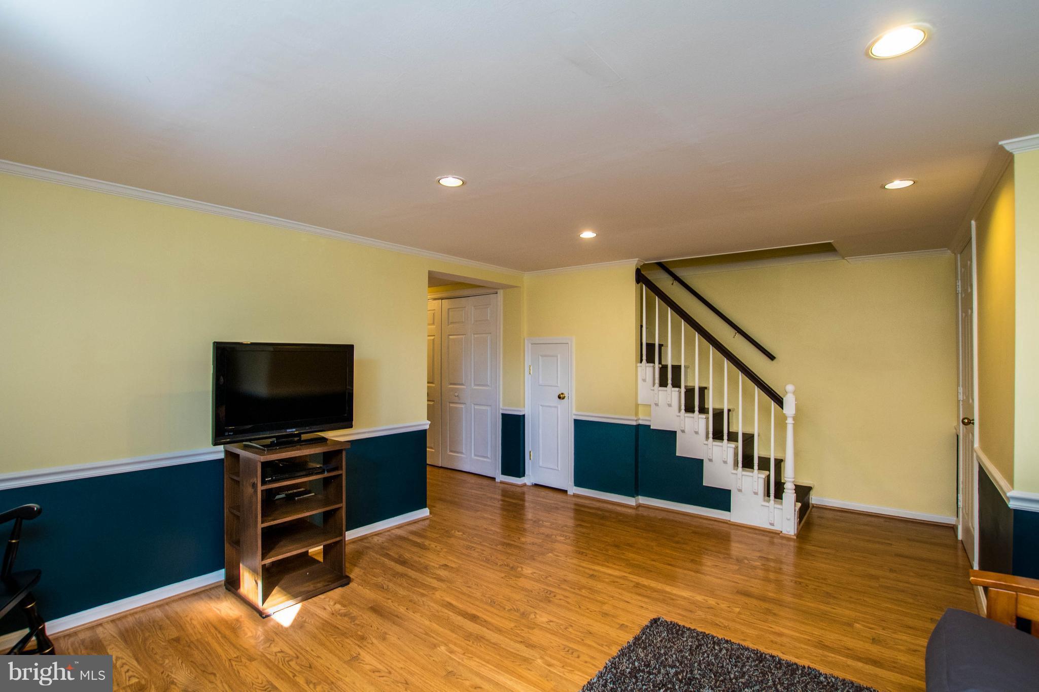 128 Overbrook Road Baltimore, MD 21212 - Photo 21 of 29 a view of a livingroom with wooden floor and a flat screen tv