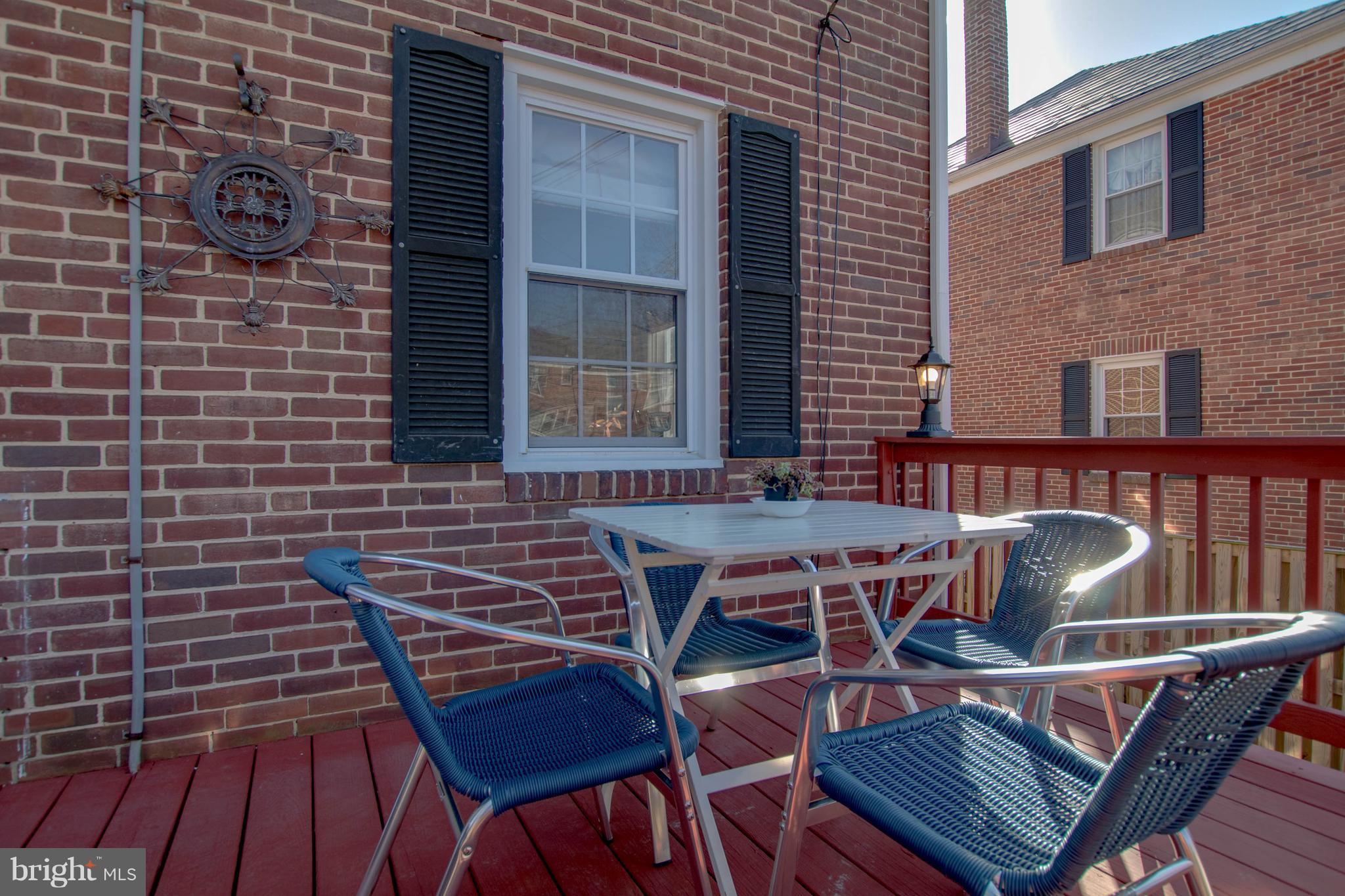 128 Overbrook Road Baltimore, MD 21212 - Photo 26 of 29 a view of a patio with a table and chairs