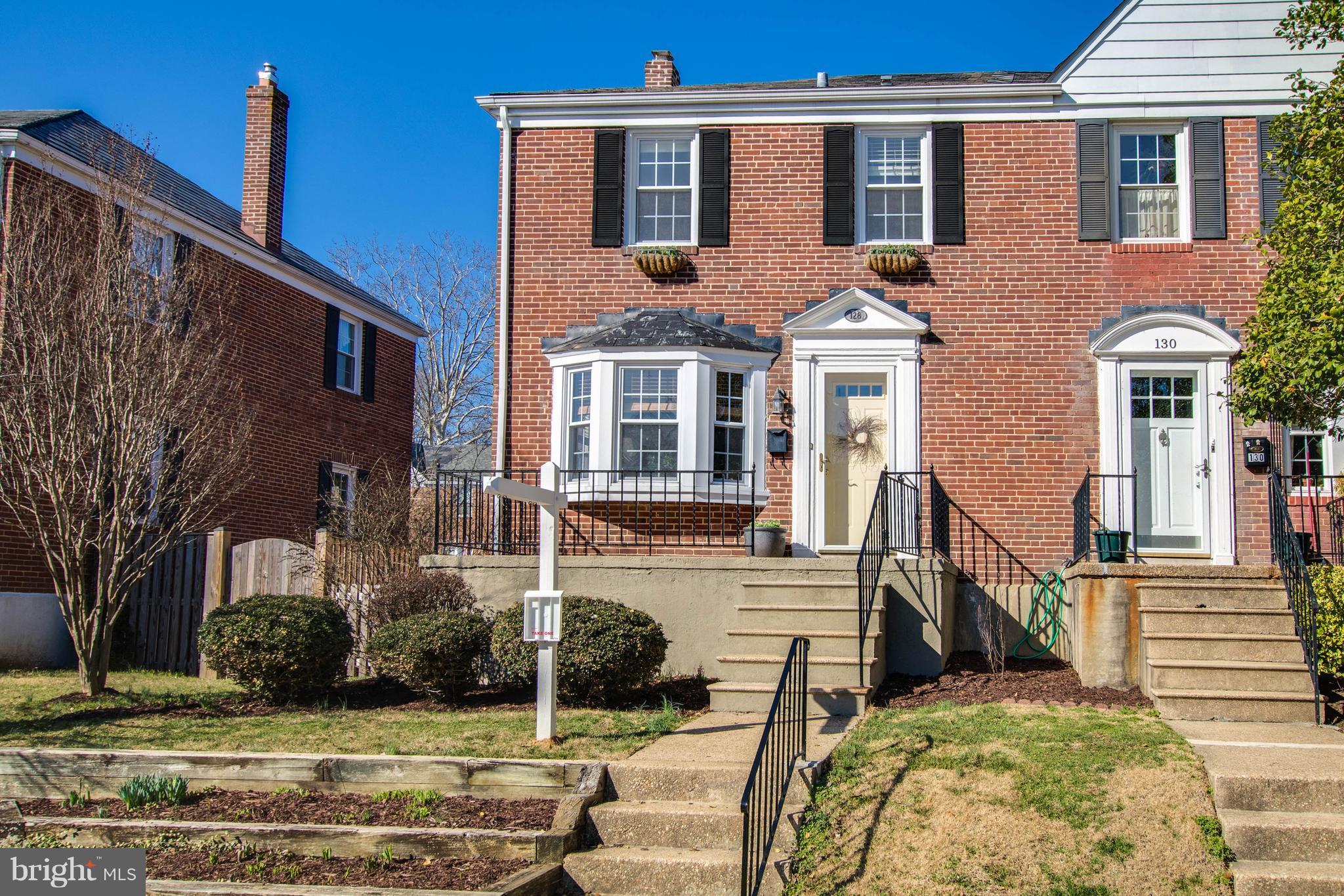 128 Overbrook Road Baltimore, MD 21212 - Photo 28 of 29 a view of a brick house with many windows and yard