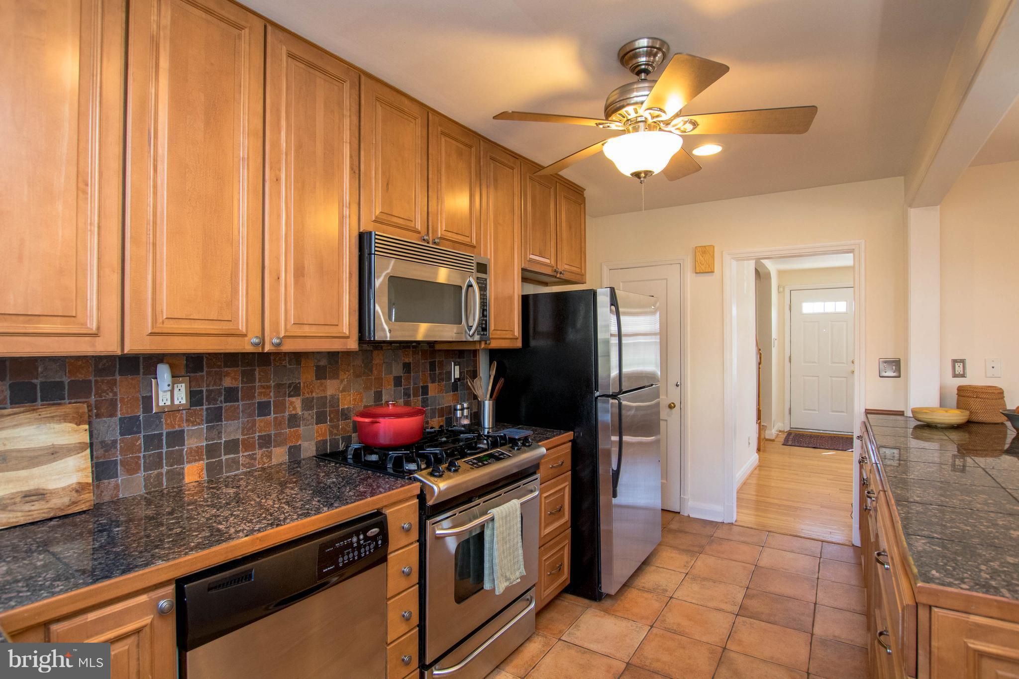 128 Overbrook Road Baltimore, MD 21212 - Photo 7 of 29 a kitchen with stainless steel appliances granite countertop a stove refrigerator and microwave