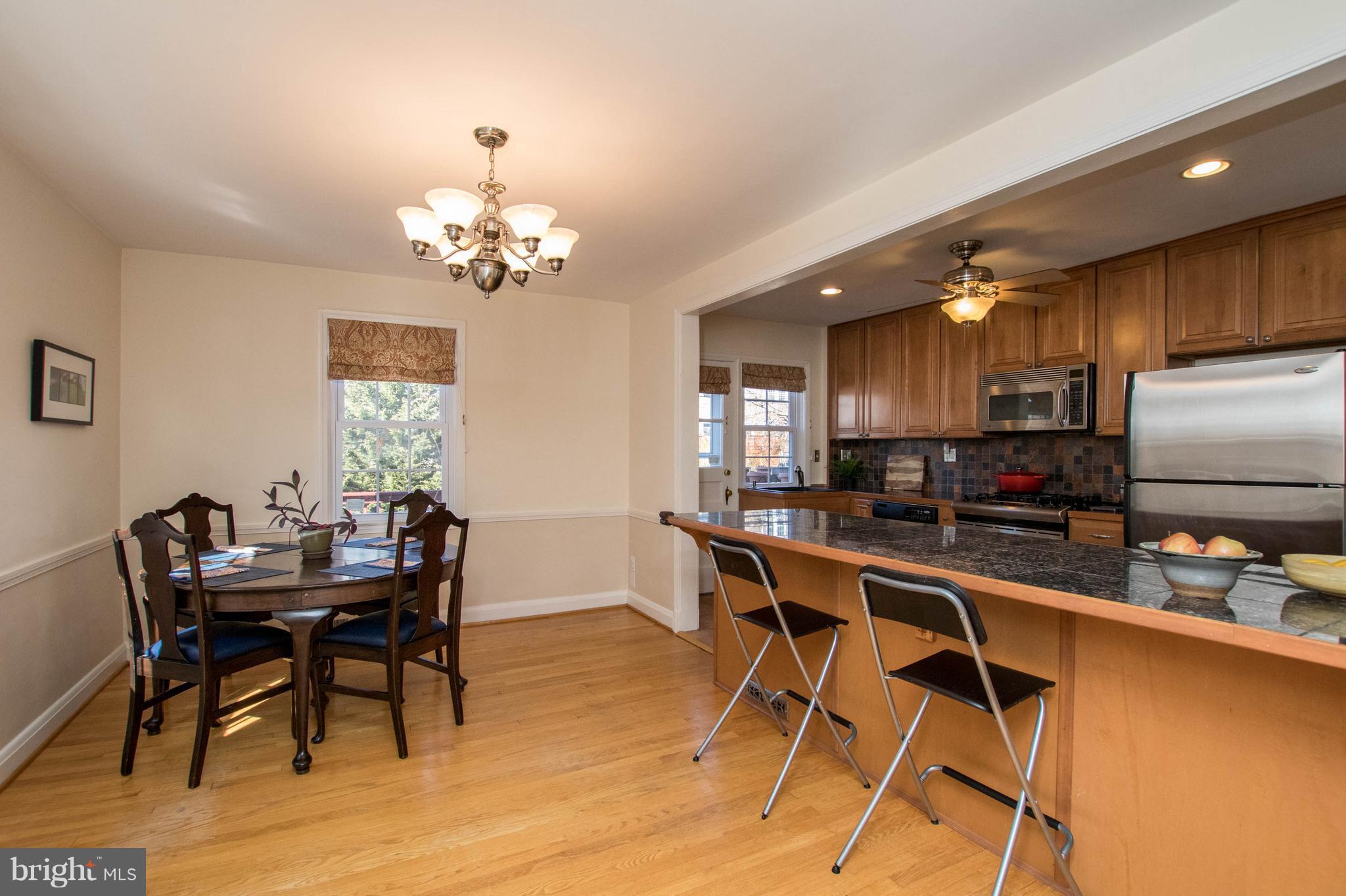128 Overbrook Road Baltimore, MD 21212 - Photo 8 of 29 a view of a dining room with furniture a chandelier and wooden floor