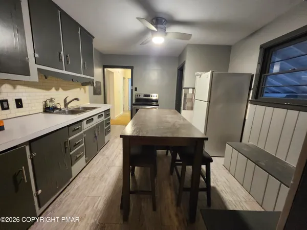 a kitchen with stainless steel appliances granite countertop a stove a sink a microwave refrigerator and island