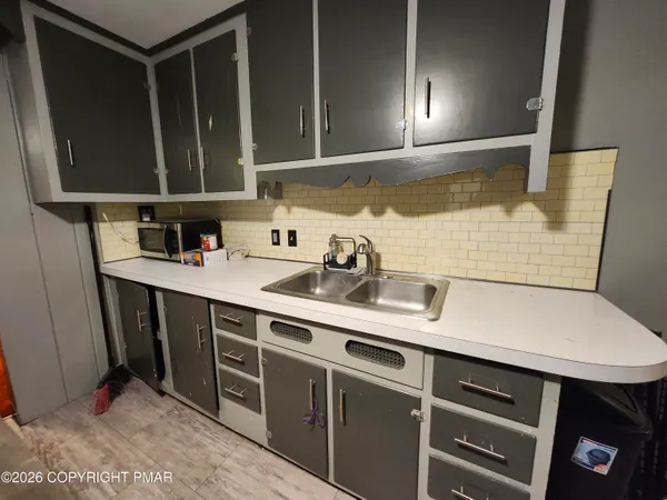 a kitchen with a sink and cabinets