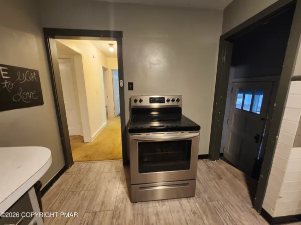 a kitchen with a stove and a refrigerator