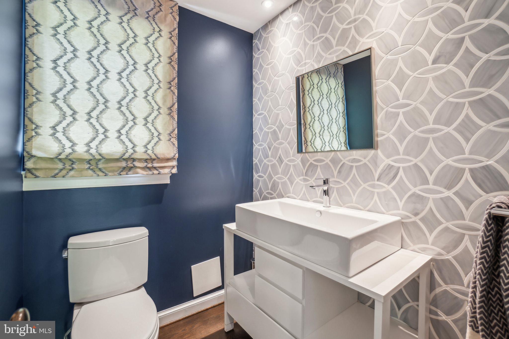 3626 Brandywine Street Northwest Washington, DC 20008 - Photo 15 of 42 a bathroom with a toilet sink and mirror