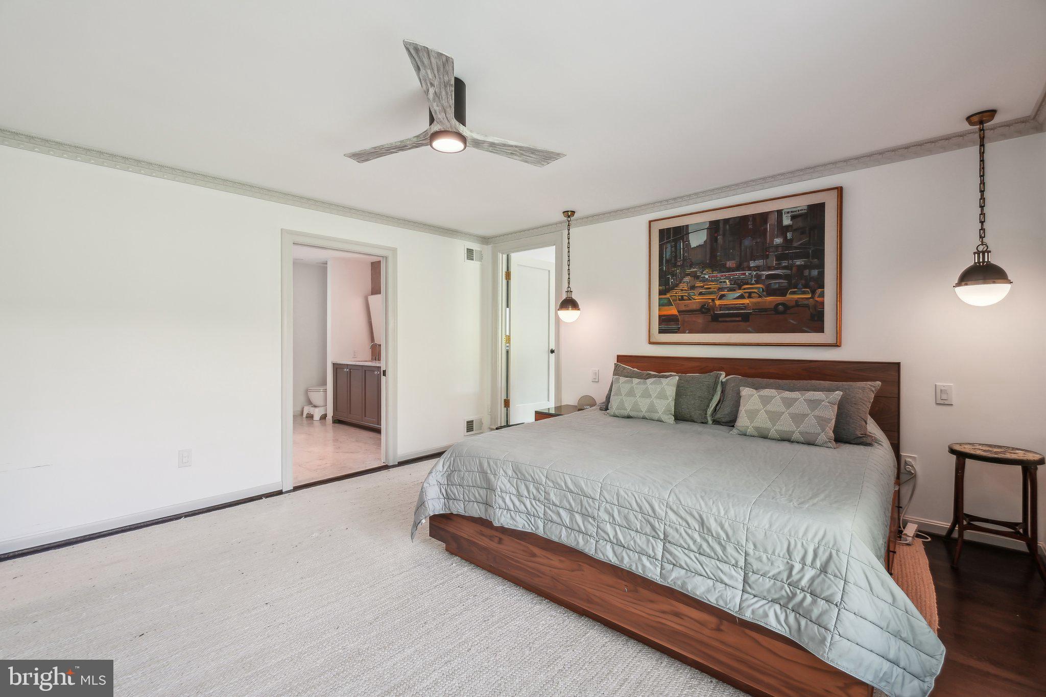 3626 Brandywine Street Northwest Washington, DC 20008 - Photo 19 of 42 a bedroom with a large bed and a chandelier