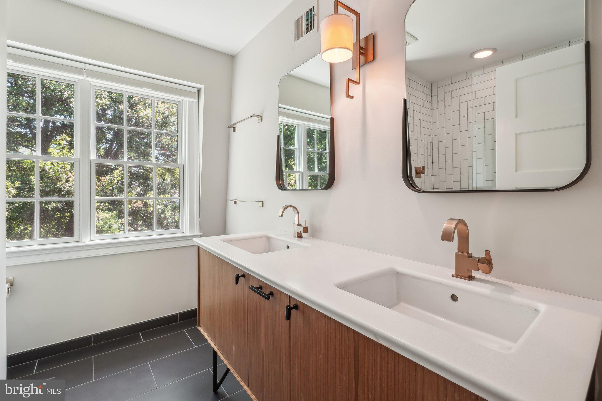 3626 Brandywine Street Northwest Washington, DC 20008 - Photo 33 of 42 a bathroom with a double vanity sink window and mirror