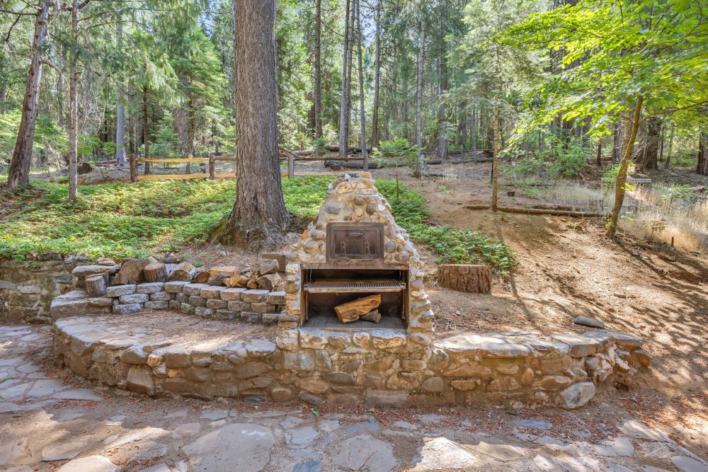 6148 Little Mountain Road Somerset, CA 95684 - Photo 6 of 39 a backyard of a house with trees and outdoor seating