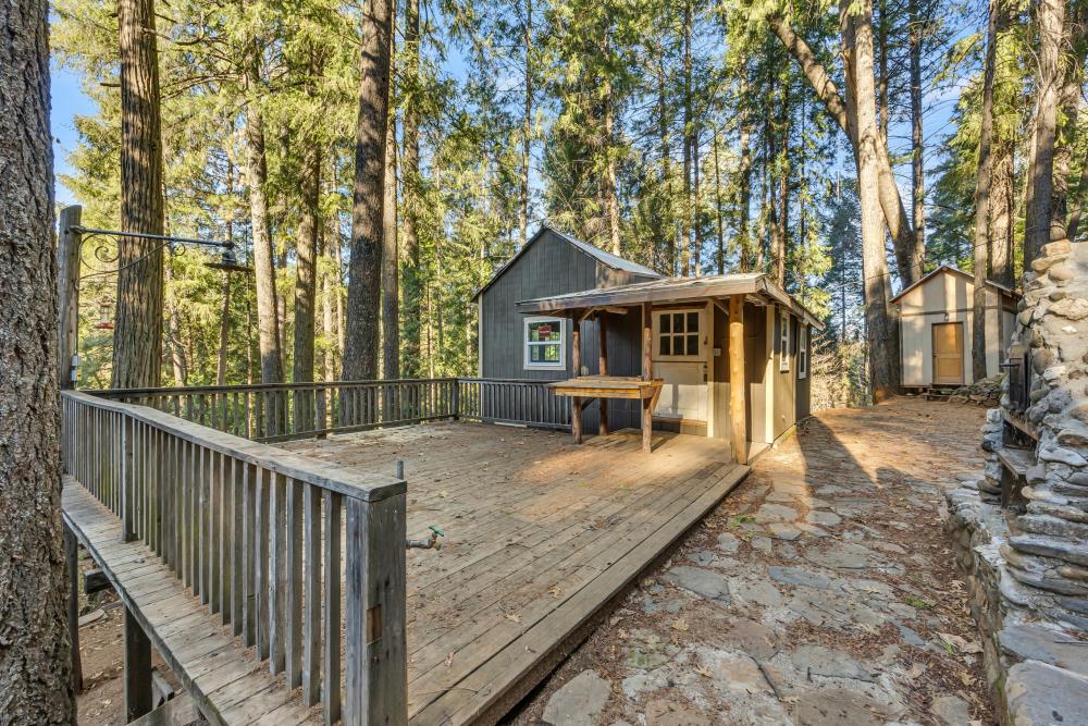 6148 Little Mountain Road Somerset, CA 95684 - Photo 7 of 39 a view of a house with wooden deck next to a yard