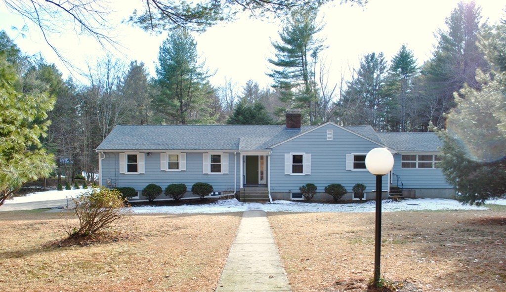 a view of a house with a yard and tree s