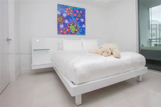 a bedroom with a bed and a painting on the wall