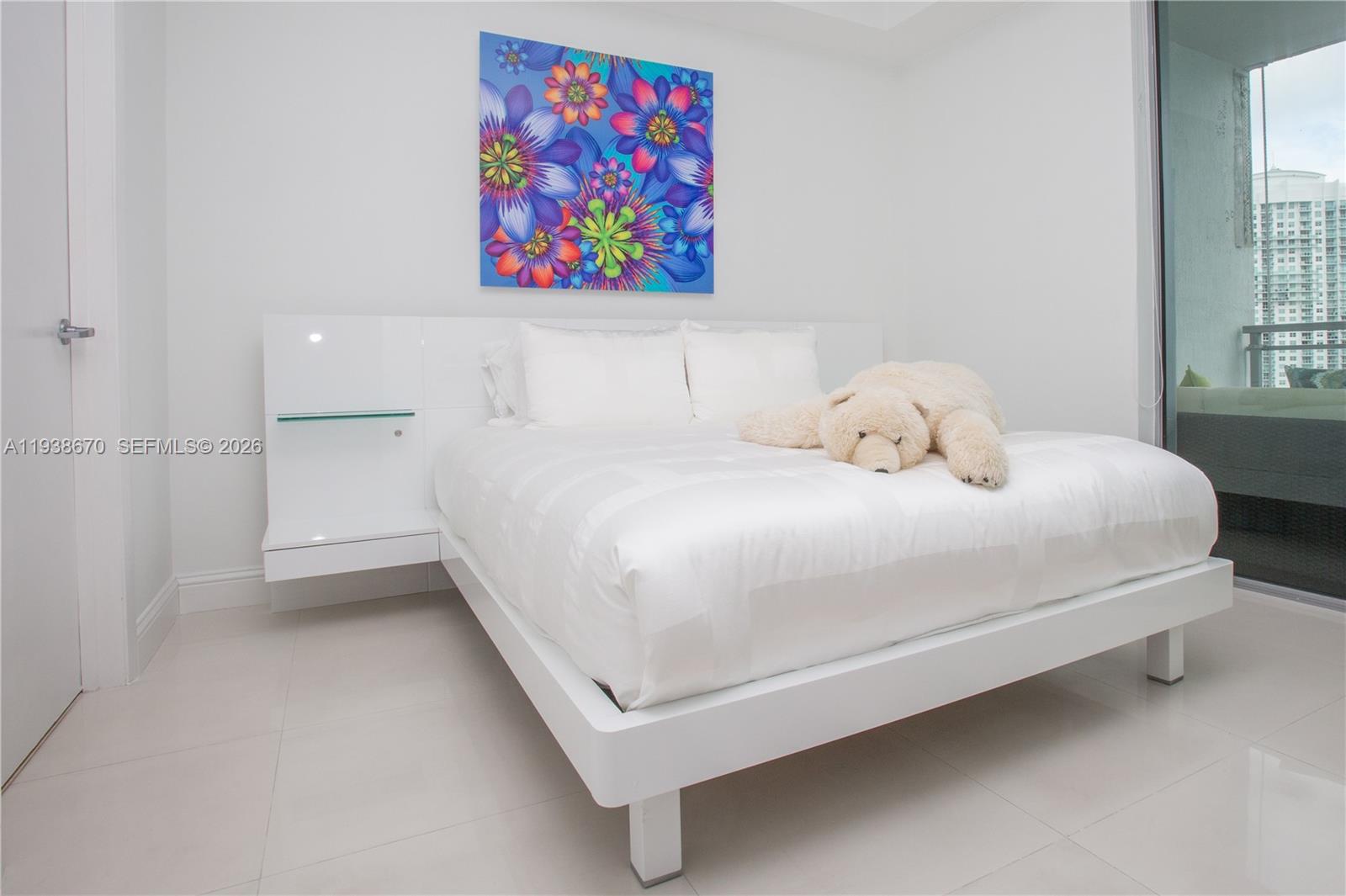 90 Southwest 3rd Street, Unit 2402 Miami, FL 33130 - Photo 12 of 28 a bedroom with a bed and a painting on the wall