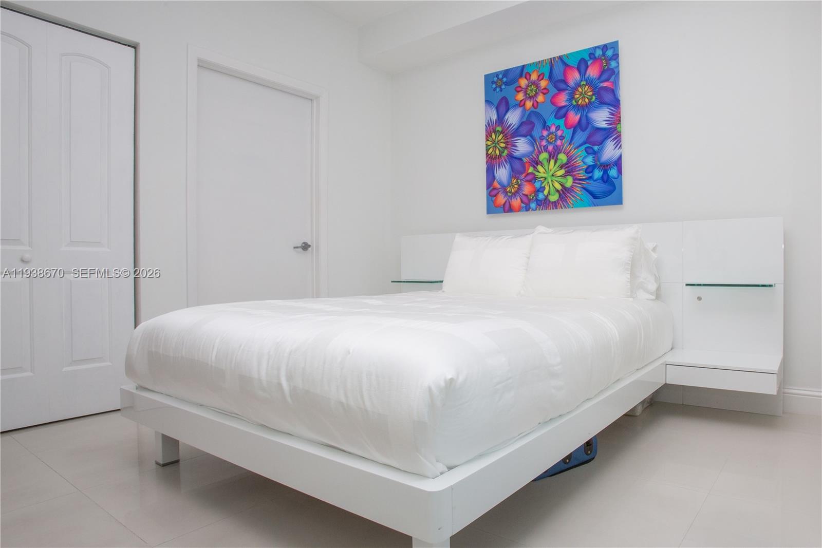 90 Southwest 3rd Street, Unit 2402 Miami, FL 33130 - Photo 13 of 28 a bed room with a bed and painting on the wall