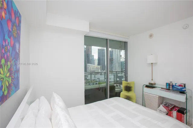 a bedroom with a bed and a table