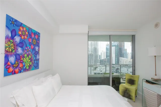 a bedroom with a bed and a painting on the wall