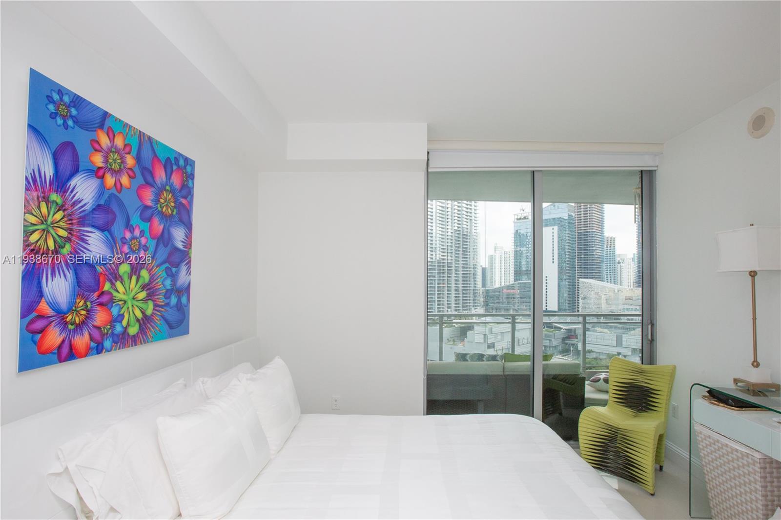 90 Southwest 3rd Street, Unit 2402 Miami, FL 33130 - Photo 15 of 28 a bedroom with a bed and a painting on the wall