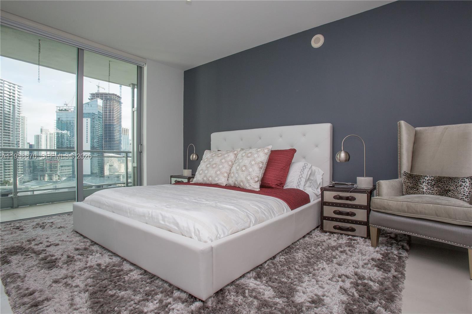 90 Southwest 3rd Street, Unit 2402 Miami, FL 33130 - Photo 17 of 28 a bedroom with a bed and large window