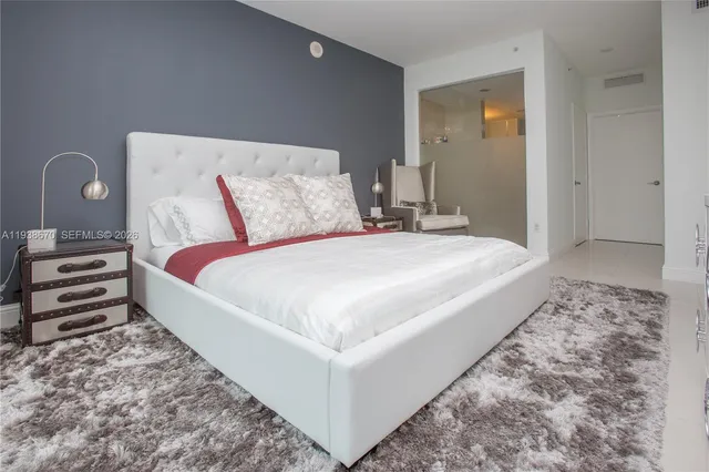 a bedroom with a bed and a dresser