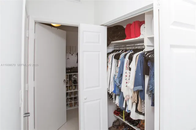 a view of walk in closet with clothes