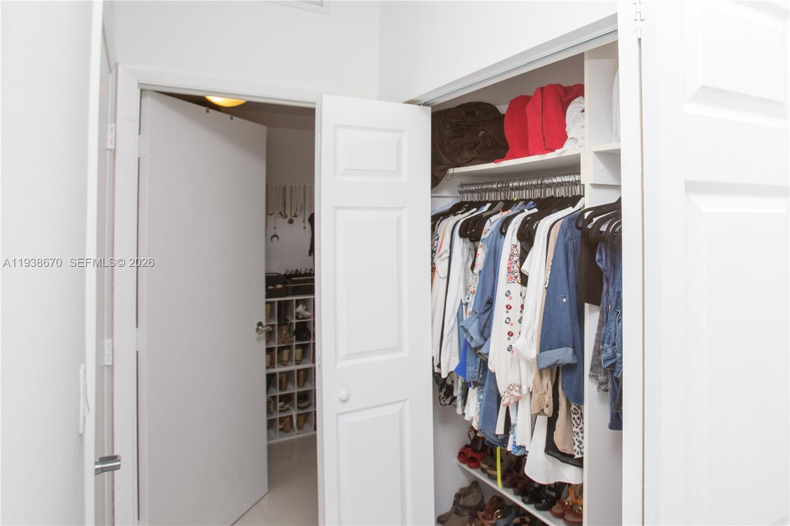 90 Southwest 3rd Street, Unit 2402 Miami, FL 33130 - Photo 23 of 28 a view of walk in closet with clothes