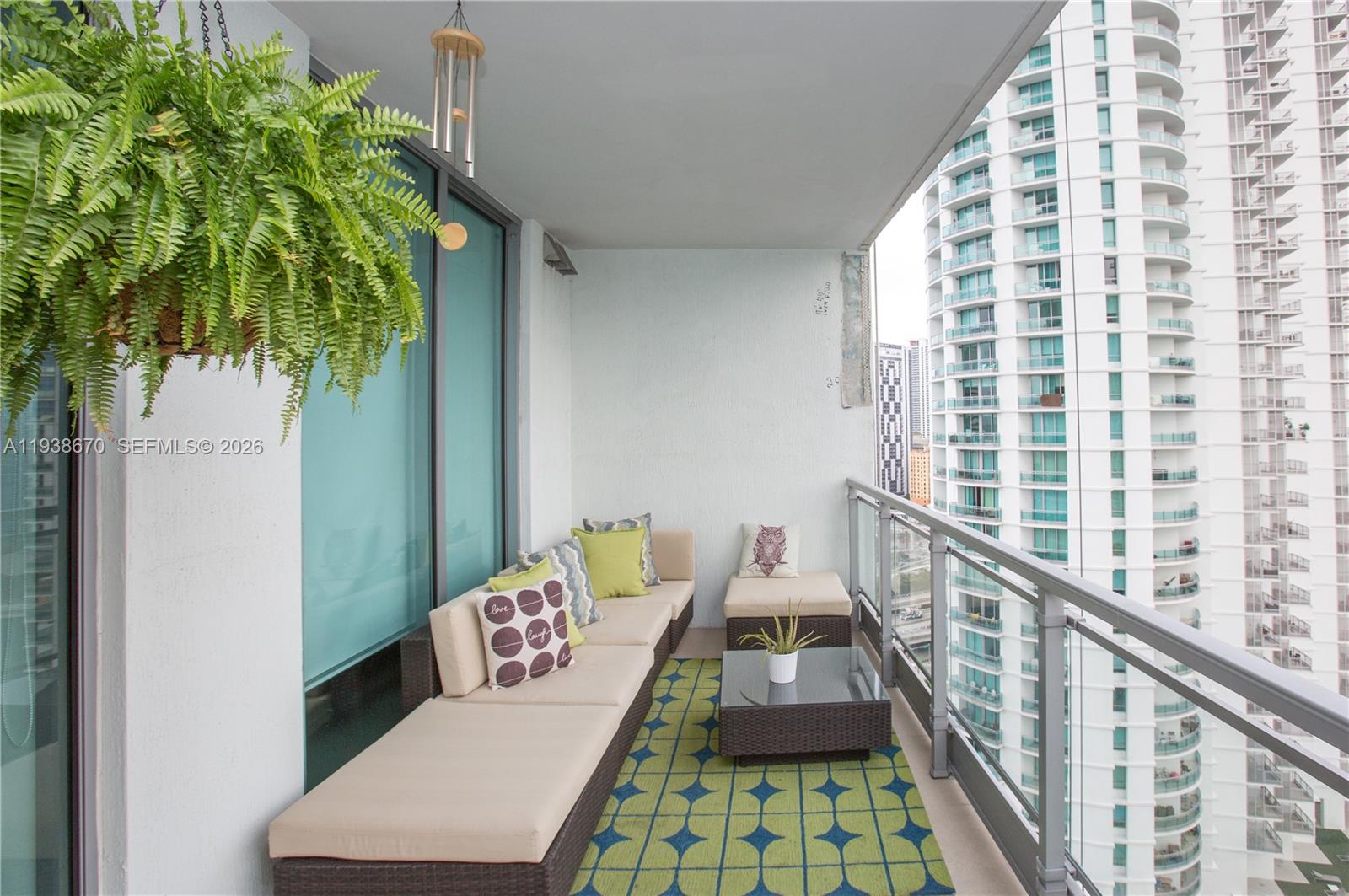 90 Southwest 3rd Street, Unit 2402 Miami, FL 33130 - Photo 24 of 28 a living room with furniture and a potted plant