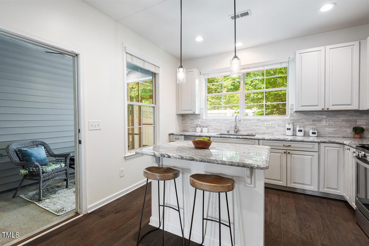 26 Intuition Circle Durham, NC 27705 - Photo 15 of 42 a kitchen with a window a sink and chairs