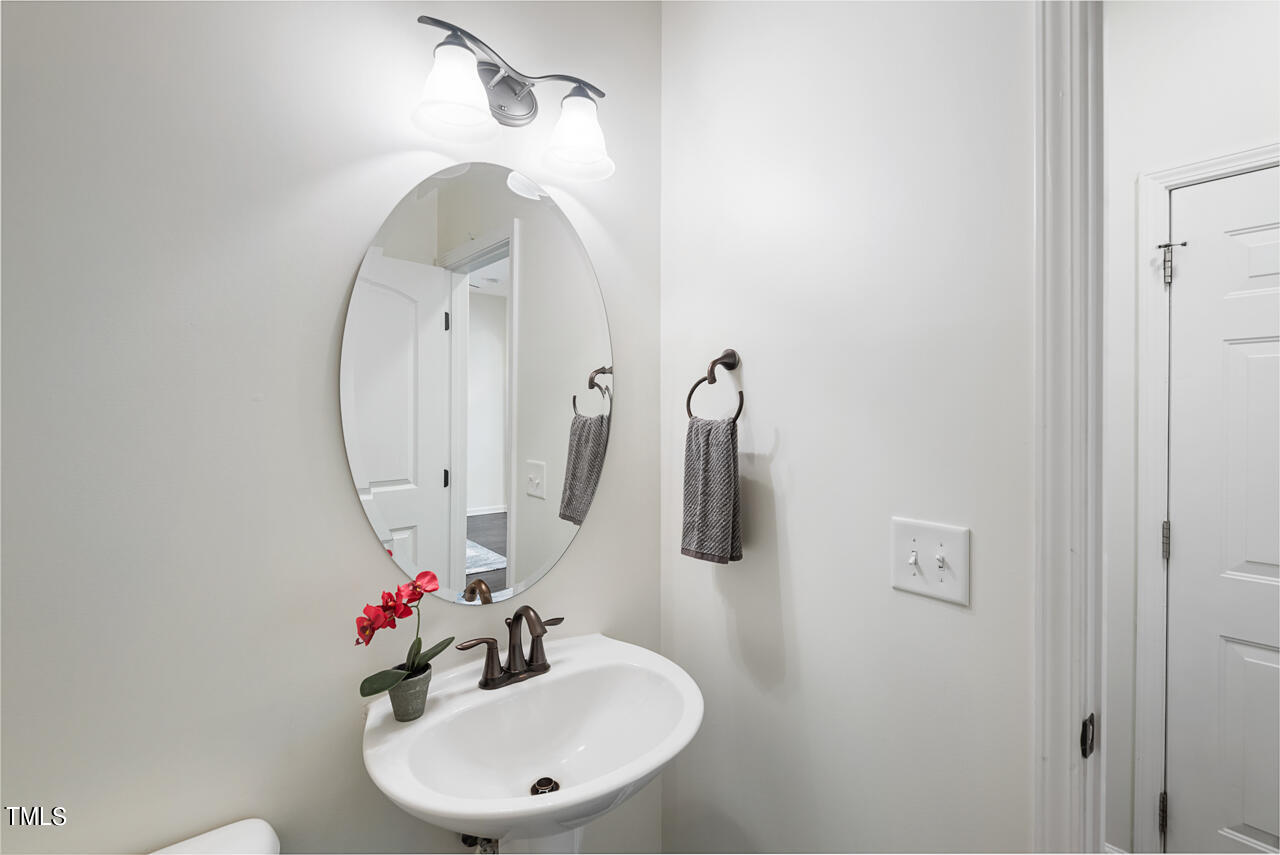 26 Intuition Circle Durham, NC 27705 - Photo 20 of 42 a bathroom with a sink vanity and a mirror