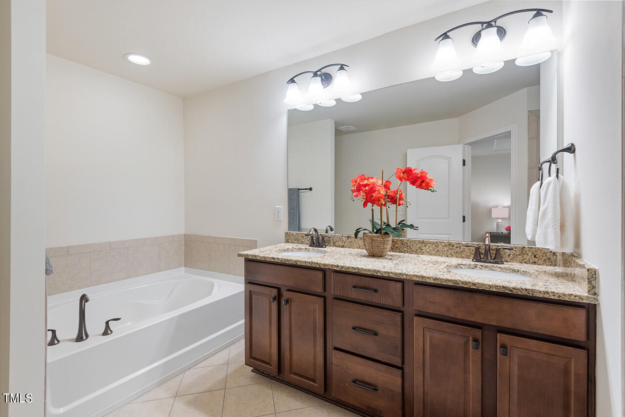 26 Intuition Circle Durham, NC 27705 - Photo 23 of 42 a bathroom with a bath tub sink mirror and vanity