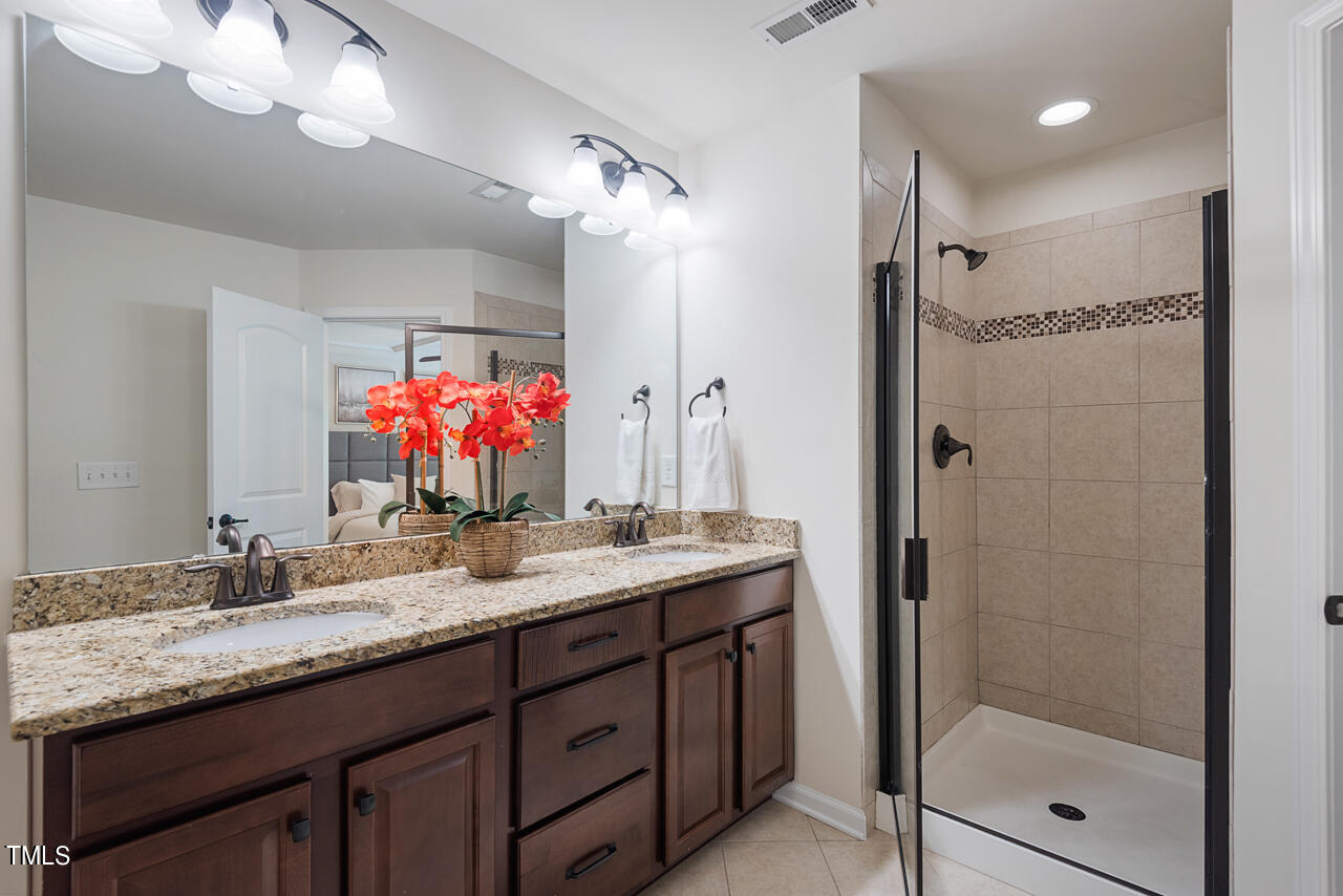 26 Intuition Circle Durham, NC 27705 - Photo 24 of 42 a bathroom with a granite countertop sink shower and a mirror