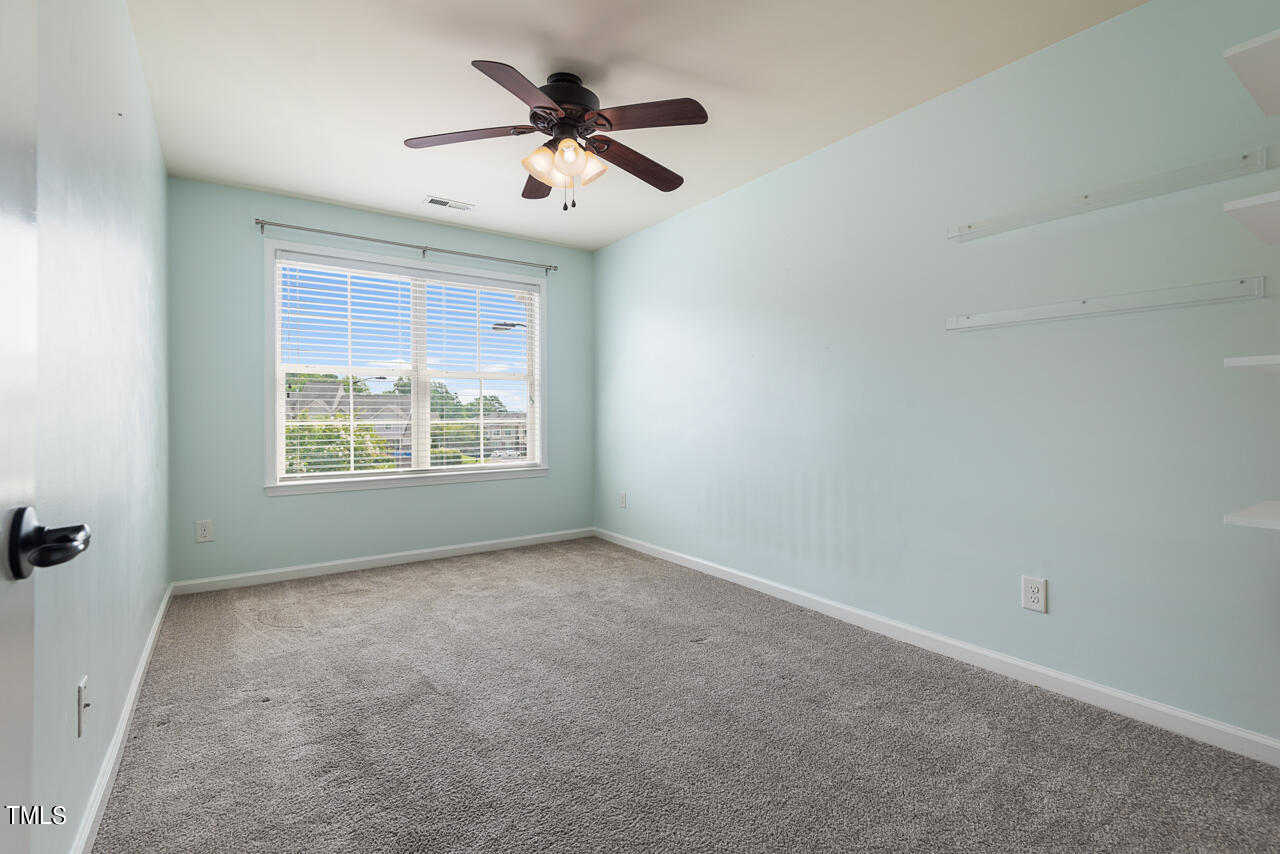 26 Intuition Circle Durham, NC 27705 - Photo 28 of 42 an empty room with windows and ceiling fan
