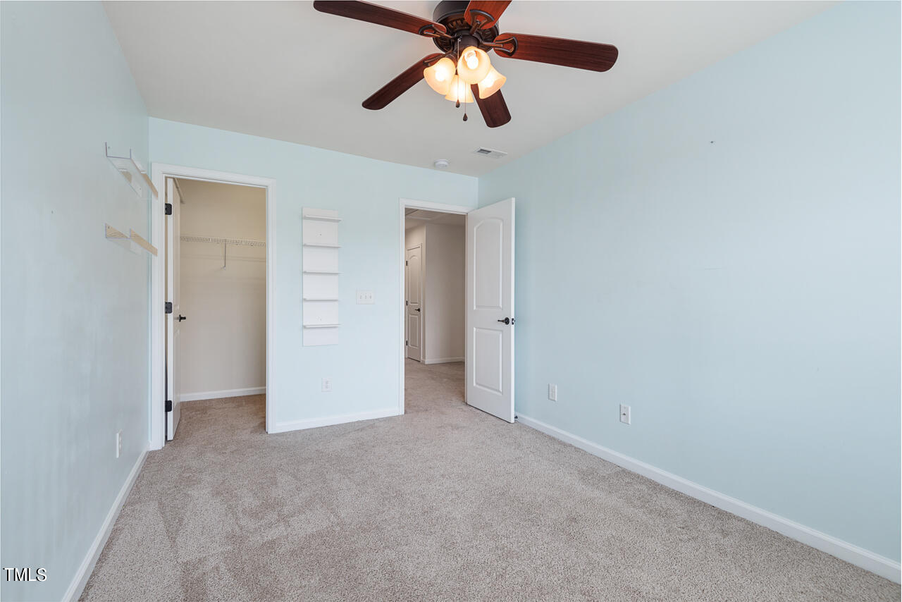 26 Intuition Circle Durham, NC 27705 - Photo 29 of 42 an empty room with closet and a chandelier fan