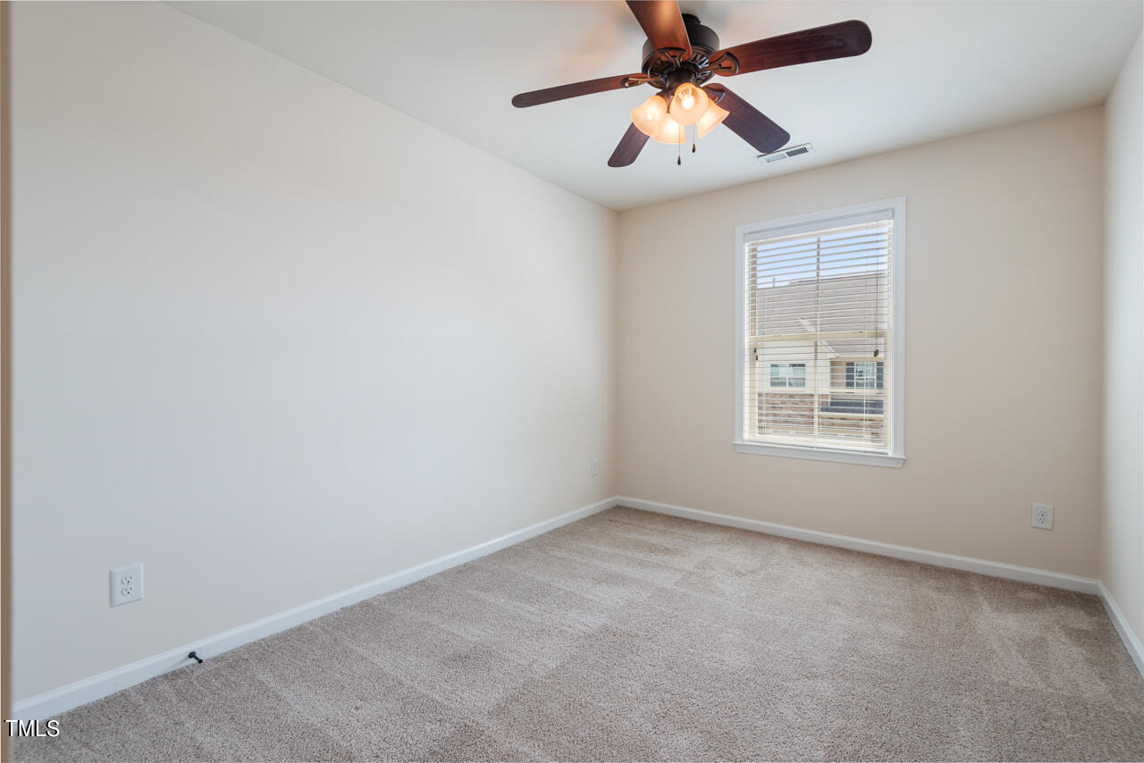 26 Intuition Circle Durham, NC 27705 - Photo 31 of 42 an empty room with windows and fan