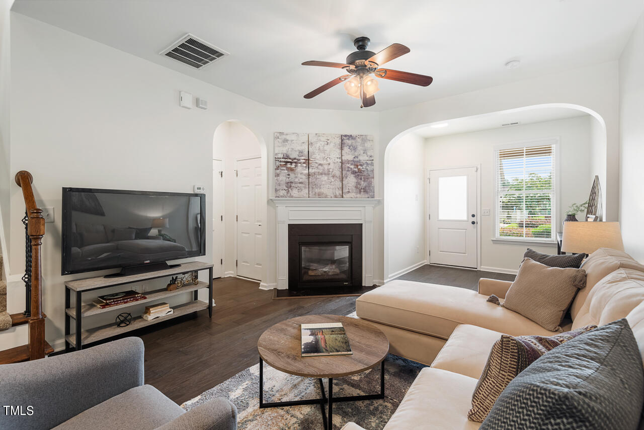 26 Intuition Circle Durham, NC 27705 - Photo 7 of 42 a living room with furniture a flat screen tv and a fireplace