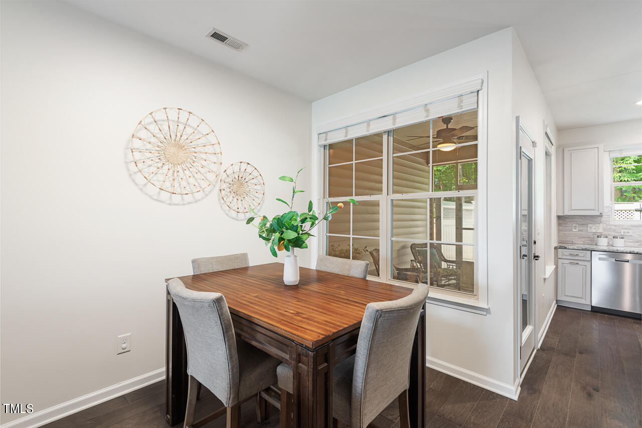 26 Intuition Circle Durham, NC 27705 - Photo 9 of 42 a dining room with furniture potted plants and wooden floor