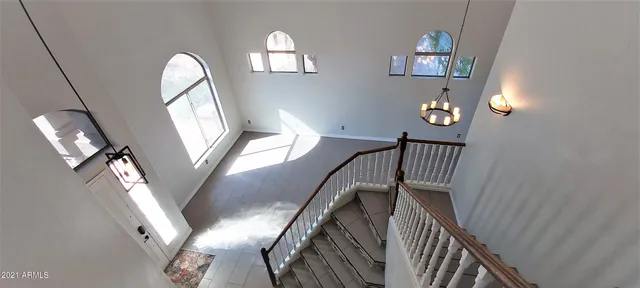 a view of entryway with white walls and cabinet