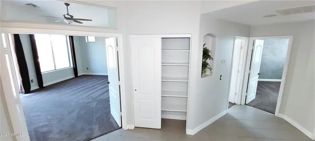 a view of room with window and ceiling fan