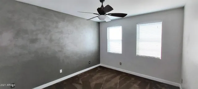 a view of an empty room with a fan
