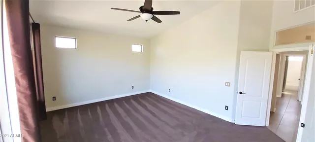 a view of a hallway with furniture and front door